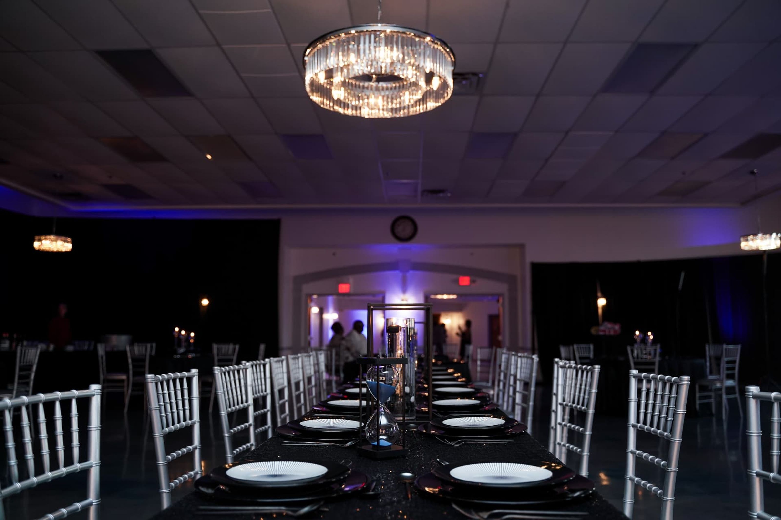 Empty event room prepared with long dining tables