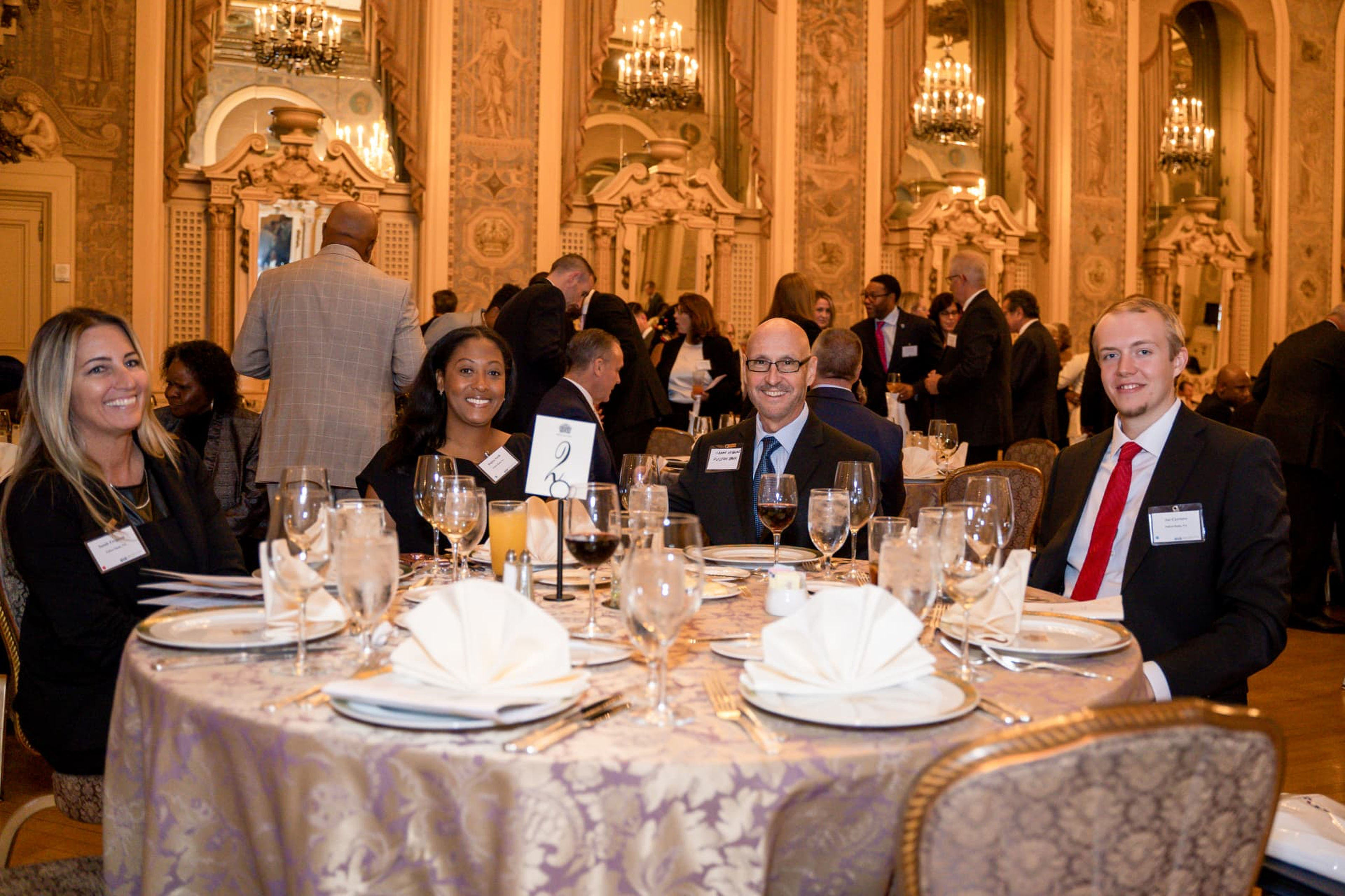 Guests seated and mingling at a formal banquet