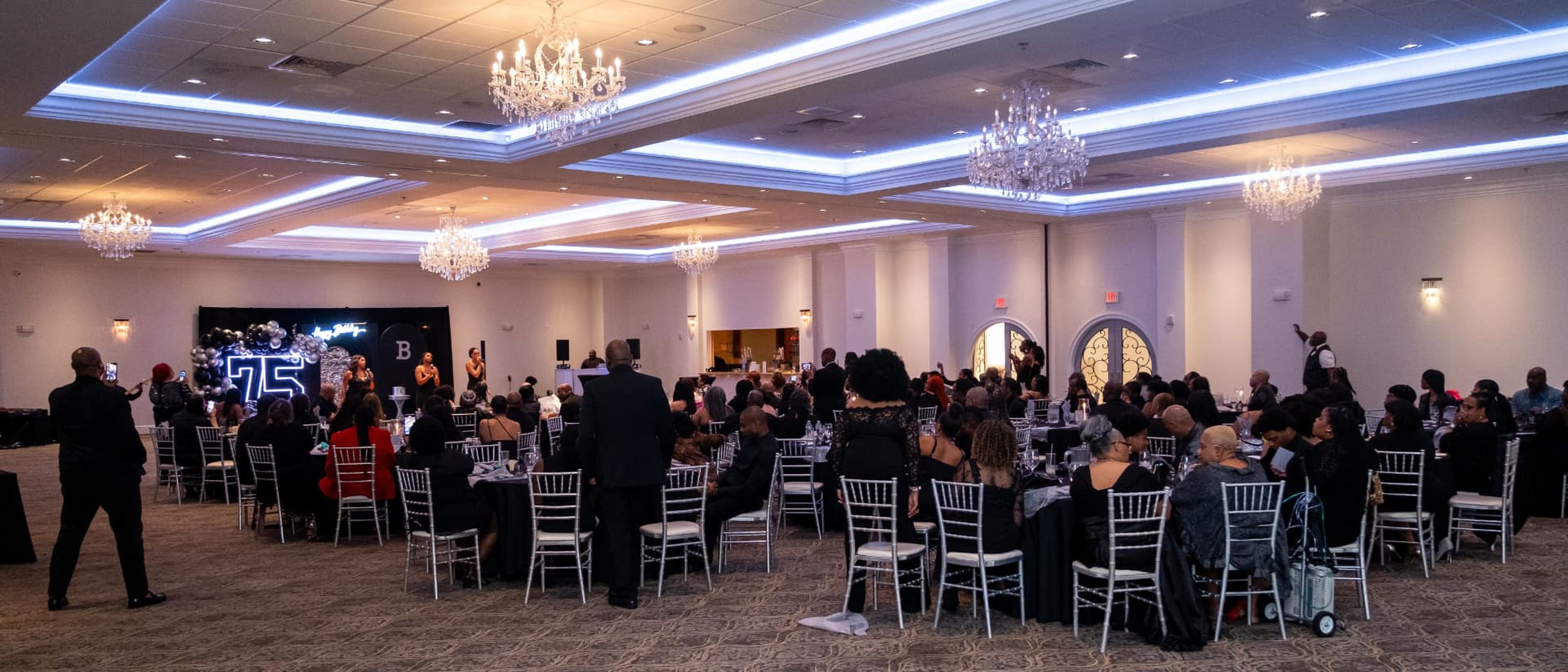 Large formal banquet in an ornate ballroom